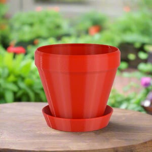 May include: A bright red plastic flower pot with a matching saucer. The pot has a flared lip and a smooth, slightly textured surface.