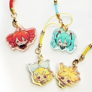 May include: Four acrylic charms featuring chibi-style anime characters with colourful hair, including red, teal, yellow, and blonde. Each charm is attached to a gold-toned lobster clasp and a braided nylon cord in matching colours: red, light blue, and yellow.