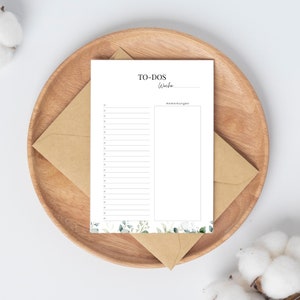 Pode incluir: Uma lista de tarefas brancas com uma borda floral. A lista tem uma se&ccedil;&atilde;o para tarefas e uma se&ccedil;&atilde;o para notas. O texto na lista diz "TO-DOS Woche Anmerkungen".