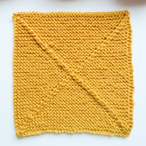 May include: A yellow knitted square dishcloth with a diamond pattern.