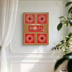 May include: A framed artwork featuring a series of red and beige panels. The red panels display a central black circle surrounded by white radial patterns. The beige panels have a central image of a cart and figures. The text "Artyzen Traditions" is visible.