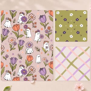 May include: Three rectangular sheets featuring distinct patterns. The largest sheet displays a light pink background with cartoon ghosts wearing flower crowns, purple tulips, and orange daisies. A smaller square sheet has a green background with white and purple flowers. A third square sheet features a light pink background with a diagonal plaid pattern in green, pink, and purple lines.