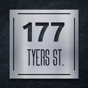 May include: A silver metal house number sign with the number 177 and the street name "TYERS ST." in black lettering.