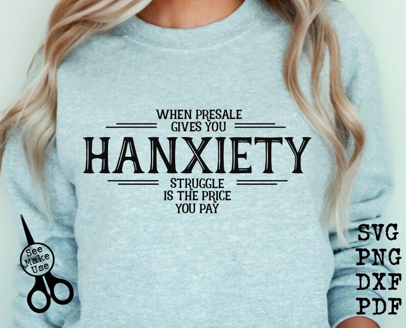 May include: A light blue sweatshirt with black text that reads "WHEN PRESALE GIVES YOU HANXIETY STRUGGLE IS THE PRICE YOU PAY".