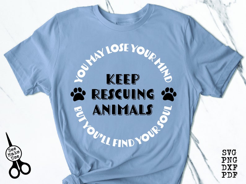 May include: Light blue t-shirt with a white circle graphic that says "You may lose your mind but you'll find your soul" with the words "Keep rescuing animals" in the center.  The graphic also includes two paw prints.