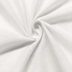 May include: White fabric with a smooth, textured surface. The fabric is folded and draped, creating soft folds and curves.