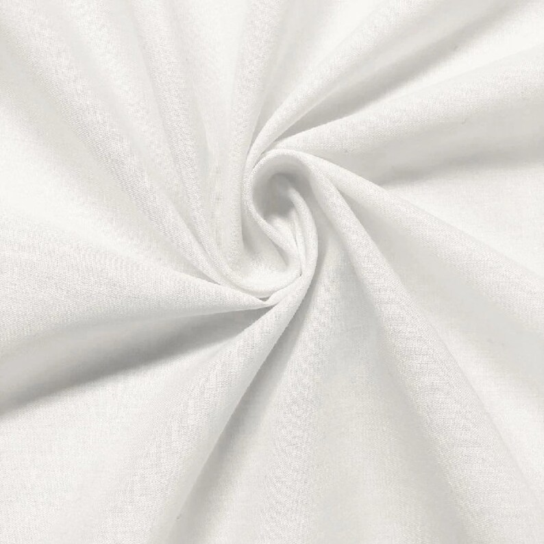 May include: White fabric with a smooth, textured surface. The fabric is folded and draped, creating soft folds and curves.