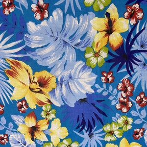 May include: A blue fabric with a tropical print featuring yellow, red, and white flowers, blue and white leaves, and a blue background.