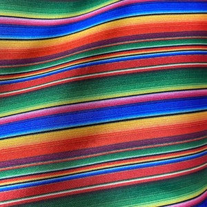 May include: Colorful striped fabric with a woven texture. The fabric features alternating stripes of red, green, blue, yellow, and pink.