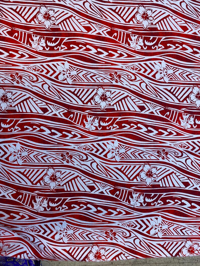May include: Red and white fabric with a repeating pattern of waves and flowers. The waves are stylized and the flowers are simple.