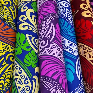 May include: Close-up of several rolls of fabric with vibrant, colorful Polynesian-inspired designs. The patterns include swirling shapes, geometric elements, and floral motifs in shades of yellow, orange, blue, green, purple, and red. The fabric appears to be tightly rolled.