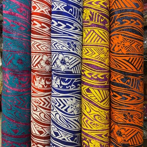 May include: Five rolls of fabric with a white and blue patterned design. The fabric has a tropical theme with flowers and geometric shapes. The fabric is in various colors, including teal, red, blue, yellow, and orange.