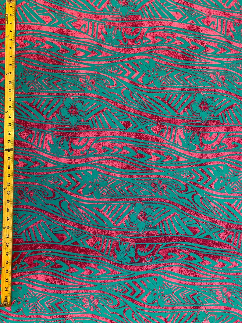 May include: Teal and pink fabric with a repeating pattern of waves and floral designs. The fabric has a distressed look, giving it a vintage feel.