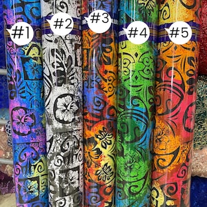 May include: Five rolls of colorful fabric with a Hawaiian floral print. The fabric is a blend of blue, green, red, yellow, and white. Each roll is labeled with a number from 1 to 5.