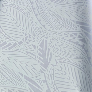 May include: A light gray fabric with a repeating white tribal pattern. The design features geometric shapes, lines, and stylized leaf-like forms. The fabric is folded, showing the pattern's continuity.