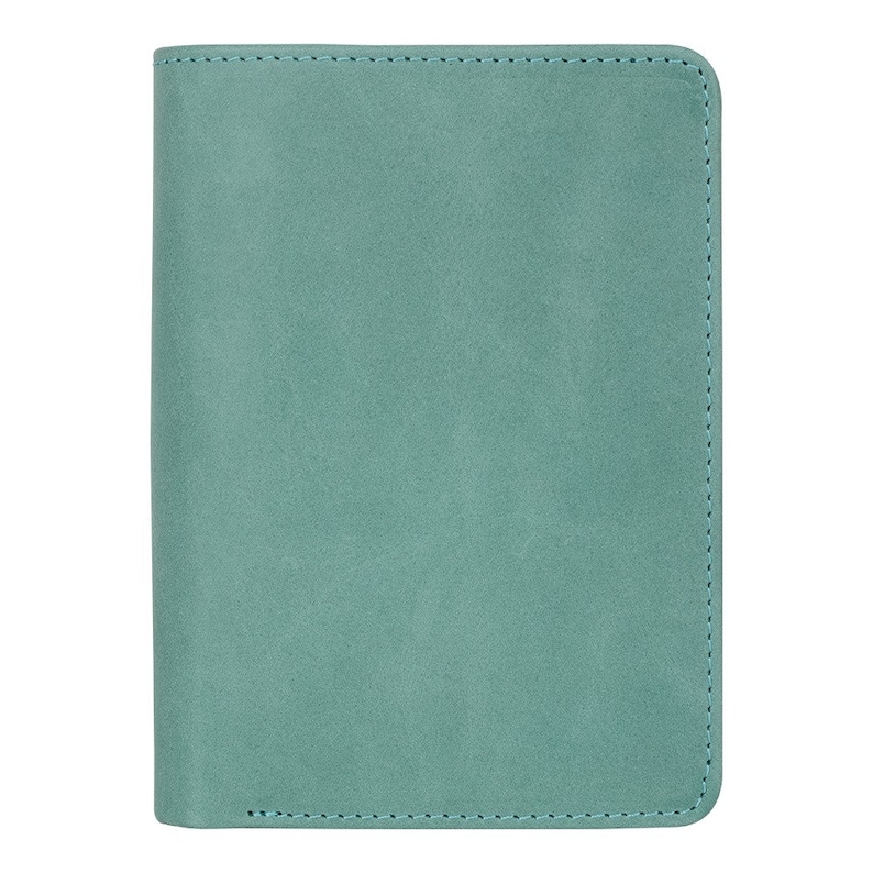 May include: A teal-colored, rectangular notebook or journal with a soft, textured cover. The edges are neatly stitched with a matching teal thread. The cover appears to be made of a suede or faux-suede material.