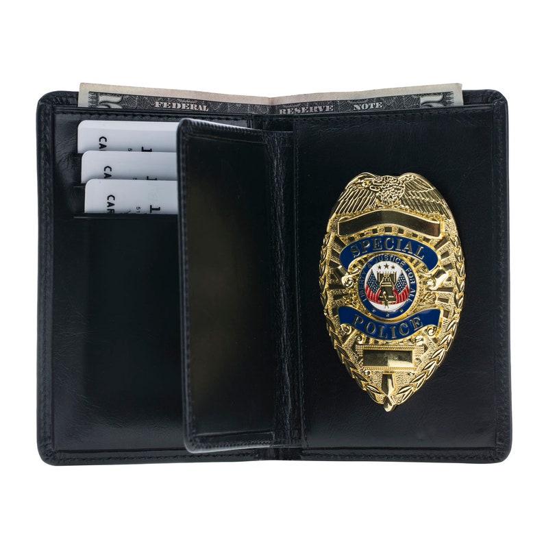 May include: Black leather wallet with a gold-colored Special Police badge. The badge has blue and red accents and the words "Special Police" and "Justice For All". Inside the wallet are several credit cards and a US dollar bill.