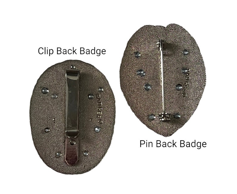 May include: Two badges with textured, oval-shaped faces. One has a clip back, the other a pin back. Both are a dark, metallic color with small, silver-colored embellishments. Text on the image reads "Clip Back Badge" and "Pin Back Badge."