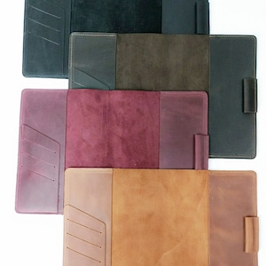 May include: Four leather-bound journals in different colors: black, brown, burgundy, and tan. Each journal has a flap closure, a pen loop, and a pocket on the front cover.