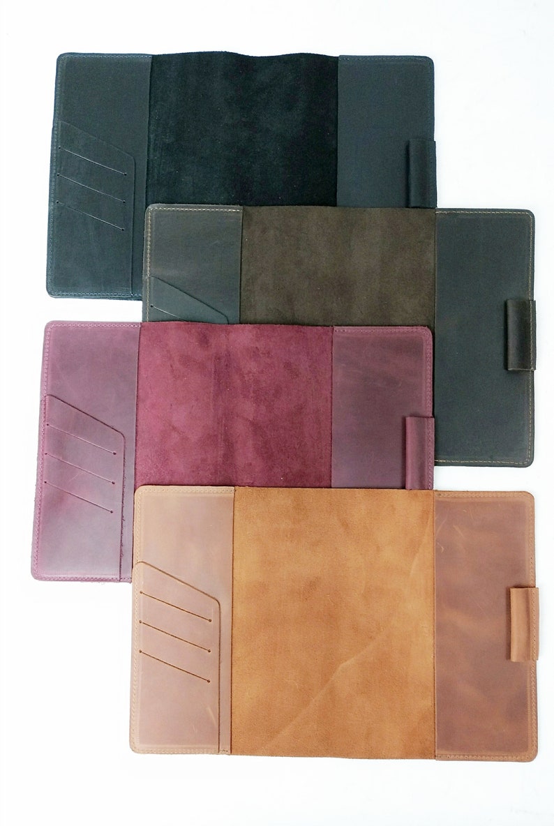 May include: Four leather-bound journals in different colors: black, brown, burgundy, and tan. Each journal has a flap closure, a pen loop, and a pocket on the front cover.