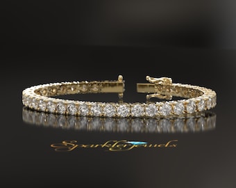 May include: A gold tennis bracelet with round diamonds set in a continuous line.