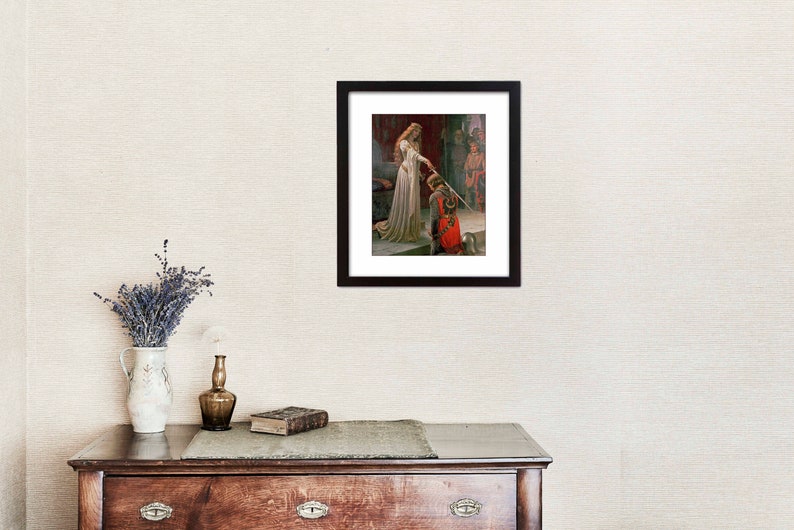 May include: A framed painting depicting a woman in a white gown presenting a sword to a kneeling man in red and gold armour. The woman is standing on a stone step and the man is kneeling on the ground. The painting is set in a medieval castle setting.