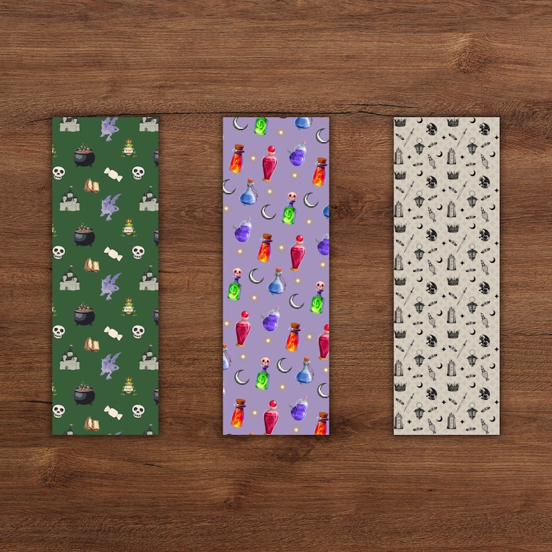 May include: Three decorative bookmarks with Halloween-themed patterns. One is green with cauldrons, skulls, and bats. Another is purple with potion bottles and moons. The third is beige with bats, moons, and magic wands.