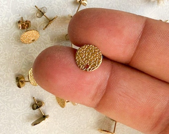 May include: Gold-toned earring findings with a textured round design. The findings have a post and a butterfly backing.