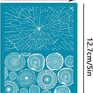 May include: A teal stencil featuring a wood grain design. The stencil is 3.9 inches wide and 5 inches tall. The design includes a large, detailed wood grain pattern at the top and several smaller tree ring patterns at the bottom.