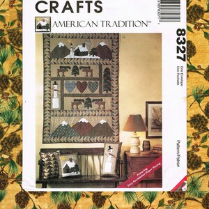 May include: A McCall's Crafts American Tradition quilt pattern featuring a winter scene with mountains, trees, and a snowman. The pattern includes instructions for foundation paper piecing. The pattern number is 8327.