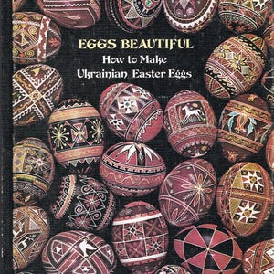 May include: A book titled "Eggs Beautiful: How to Make Ukrainian Easter Eggs" with a cover featuring a colourful arrangement of intricately decorated eggs.