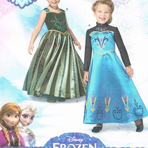 May include: Simplicity home sewing pattern for children's costumes. The image shows two young girls wearing dresses inspired by the Disney movie Frozen. The pattern includes sizes U.S. 3-8. The Disney Frozen logo is visible.
