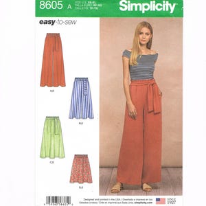 May include: Simplicity sewing pattern 8605 features easy-to-sew wide-leg pants and skirts. The pattern includes various styles, such as solid rust-colored pants, striped skirts, and floral skirts. The model is wearing rust-colored wide-leg pants. Size XS-XL.