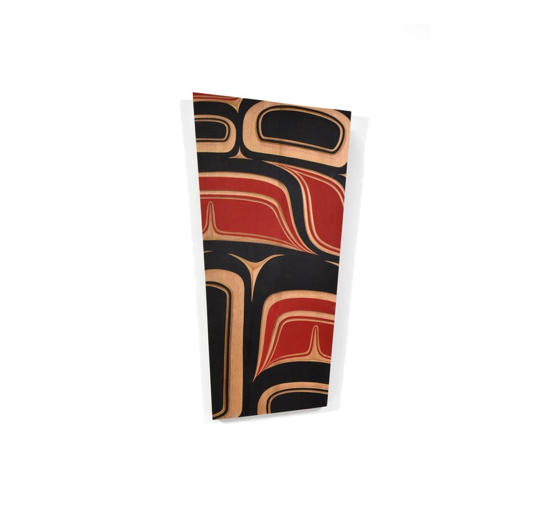May include: A wooden wall art piece with a geometric design in black, red, and brown. The design is reminiscent of a traditional Native American art style.