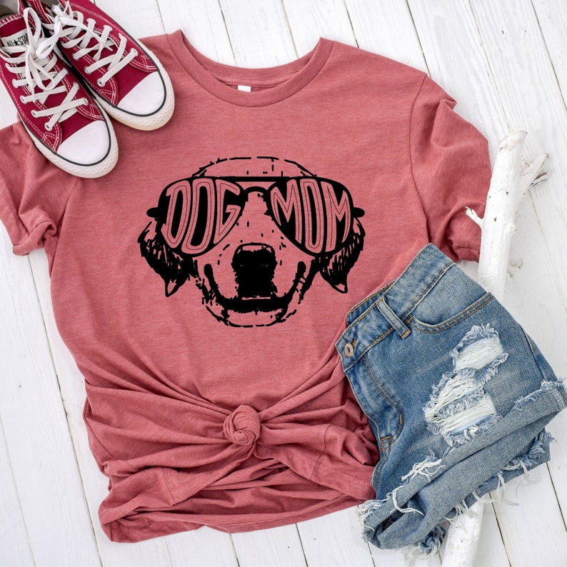 Dog Mom T-Shirt in pink shown with jean shorts and red sneakers.