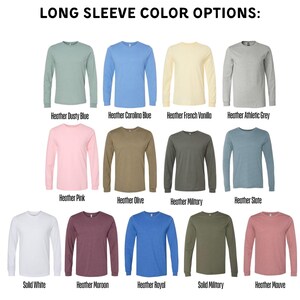 a collection of long-sleeve t-shirts in various colors, including solid white, heather dusted blue, heather olive, heather military, heather slate, heather pink, heather maroon, heather royal, and heather mauve.