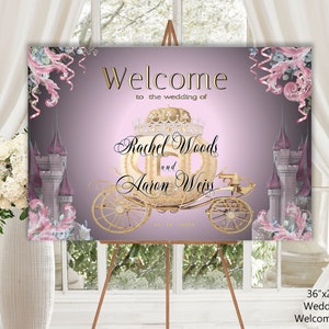 May include: A 36 by 24 inch wedding welcome sign with a pink and purple background. The sign features a gold carriage with a crown on top, and the text "Welcome to the wedding of Rachel Woods and Aaron Weiss".
