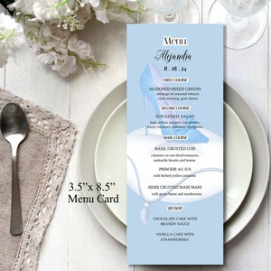 May include: A light blue menu card with a blue glass slipper design. The menu is for a wedding reception on August 18, 2024, and includes a four-course meal: Seasoned Mixed Greens, Sun Kissed Salad, Basil Crusted Cod, and a choice of Chocolate Cake with Brandy Sauce or Vanilla Cake with Strawberries.