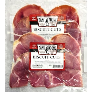 May include: A package of Dan'l Boone Country Ham biscuit cuts. The ham slices are pink and red, with a white and red label that reads "Biscuit Cuts". The package also says "Cook & Serve".