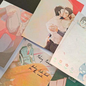 May include: A collection of illustrated paper prints featuring various scenes, including two figures embracing, a person in a suit at a desk with the text Meeting Overview and Checking Sales Chart for the month, and a small blue character with flowers.