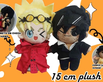 May include: Two plush dolls, approximately 6 inches tall, with anime-style features. One doll has yellow hair, glasses, and a red coat. The other has black hair and a black suit. The dolls have magnets on their cheeks and hands.