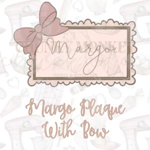 May include: A pink and brown cookie cutter in the shape of a rectangular plaque with a scalloped edge and a large bow on top. The text "Margo" is written in cursive inside the plaque. The text "Margo Plaque with Bow" is written below the plaque.