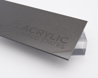May include: A close-up of a dark gray acrylic sheet with the text "ACRYLIC UNITED STATES" embossed on the surface.