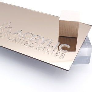 May include: A sheet of rose gold acrylic mirror with the text "Acrylic United States" etched into the surface.