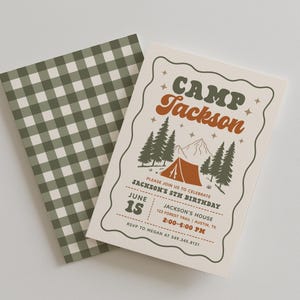 May include: A rectangular birthday invitation card featuring a camping theme with a tent, pine trees, and mountains. The text reads CAMP Jackson, PLEASE JOIN US TO CELEBRATE JACKSON'S 5TH BIRTHDAY, JUNE 15, 2:00-4:00 PM, and RSVP TO MEGAN AT 549.345.8121.