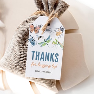 May include: A white thank you tag with a blue border and the text "THANKS for buzzing by! LOVE, JACKSON". The tag is decorated with a colorful illustration of various insects, including a butterfly, dragonfly, beetle, and spider.
