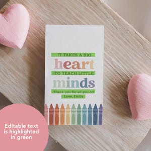 May include: A printable card with the text "IT TAKES A BIG heart TO TEACH LITTLE minds Thank you for all you do! Love, Emily" and a row of colorful crayons at the bottom.