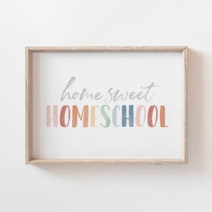May include: A framed print with the text "home sweet HOMESCHOOL" in a rainbow of colors. The text is in a watercolor style.