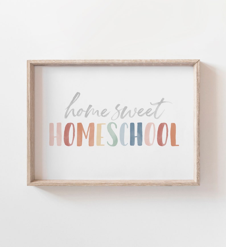 May include: A framed print with the text "home sweet HOMESCHOOL" in a rainbow of colors. The text is in a watercolor style.