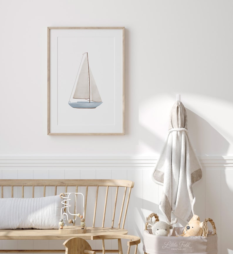May include: A framed watercolour painting of a sailboat with a white sail and a light blue hull. The painting is set against a white background.